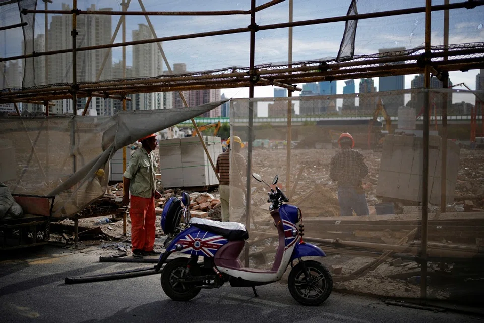 Workers work at a demolition site, following the Covid-19 outbreak, in Shanghai, China, 9 September 2022. (Aly Song/Reuters)