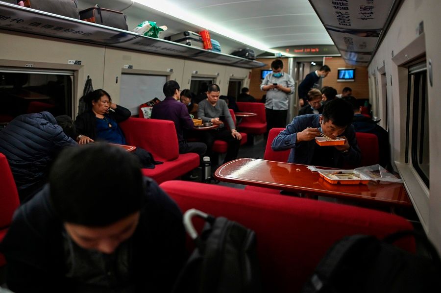 Passengers travel in a train heading to Wuhan, in Shanghai on 19 November 2020. (Hector Retamal/AFP)