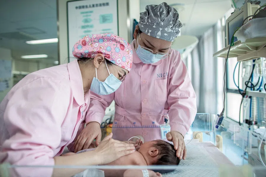Nurses take care of a newborn baby at a hospital in Xinghua, Jiangsu province, China, on 10 May 2024. (AFP)