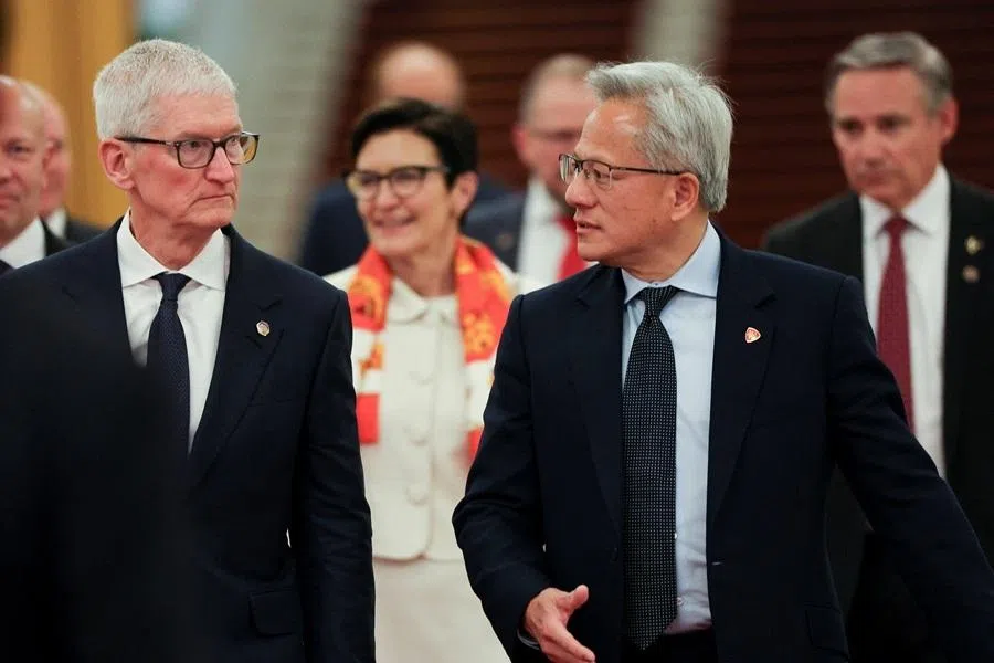 Nvidia CEO Jensen Huang and Apple CEO Tim Cook arrive for the meeting between Chinese Premier Li Qiang and US business representatives, at the Great Hall of the People in Beijing, China, 14 May 2026.