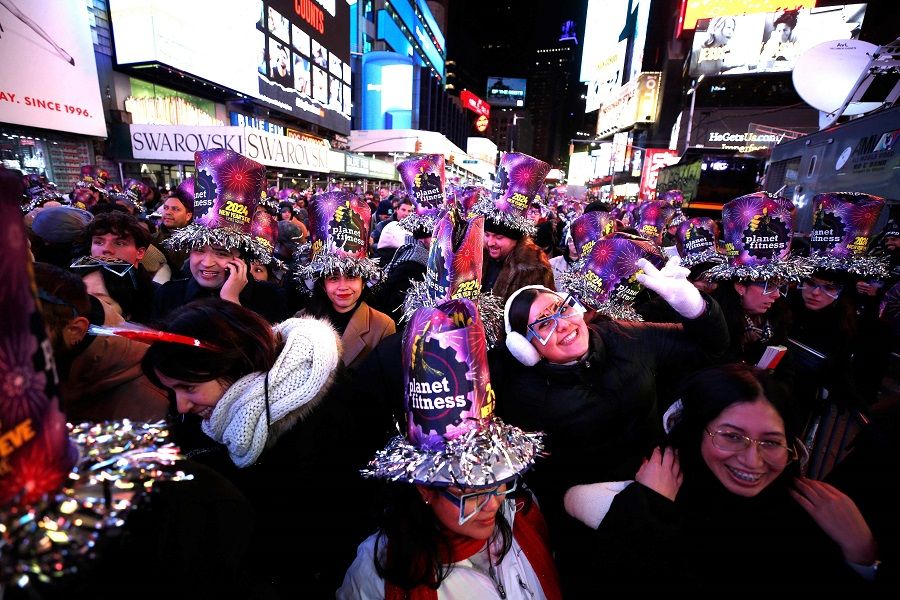 Revelers pose as they celebrate New Year's Eve in Times Square on 31 December 2023, in New York City. (John Lamparski/AFP)