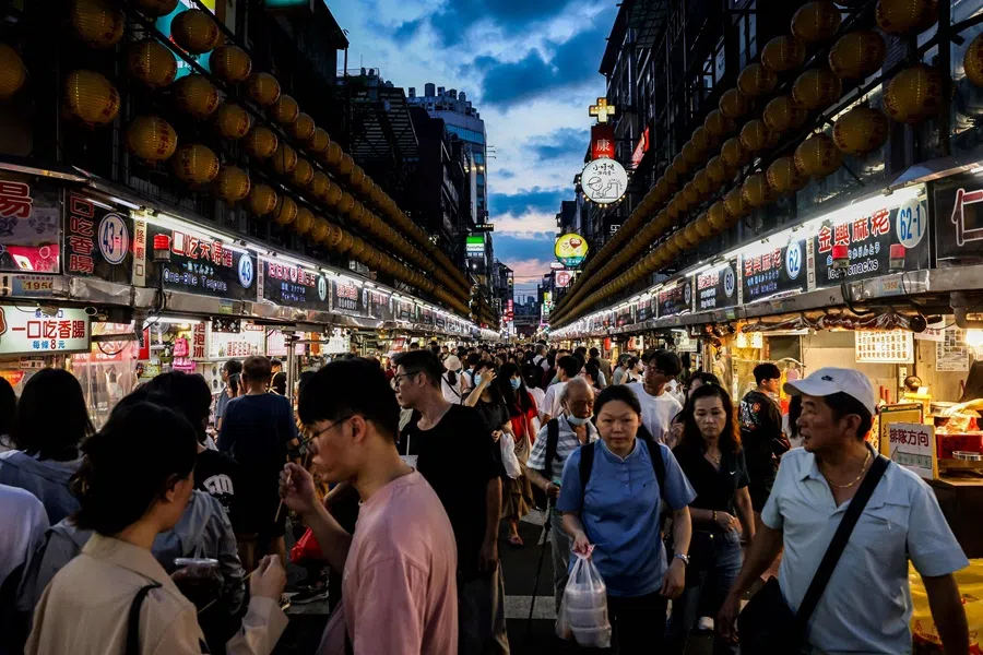 Visitors walk around a local night market in Keelung, Taiwan, on 26 June 2025. (I-Hwa Cheng/AFP)