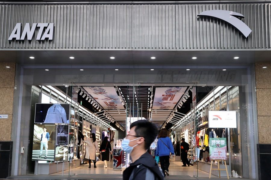 A man walks past a store of Chinese sportswear firm Anta Sports at a shopping mall in Beijing, China, 25 March 2021. (Florence Lo/Reuters)