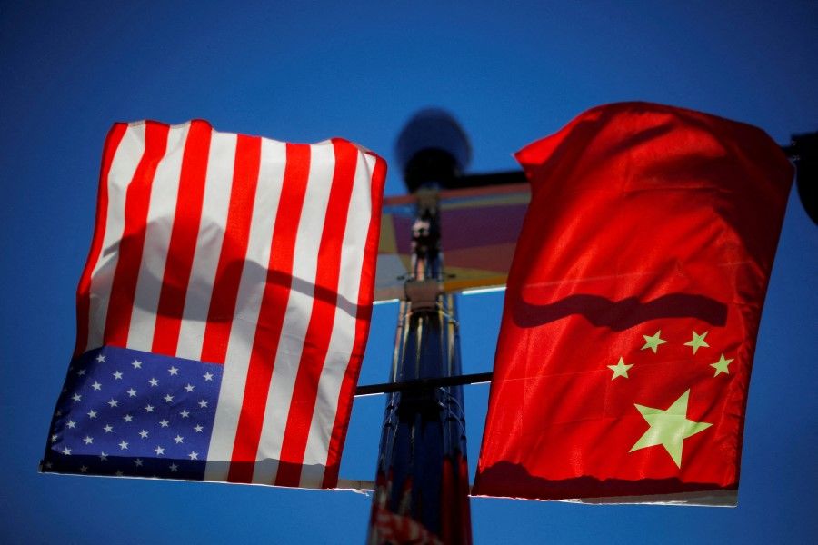 The flags of the United States and China fly from a lamppost in the Chinatown neighborhood of Boston, Massachusetts, US, on 1 November 2021. (Brian Snyder/Reuters)