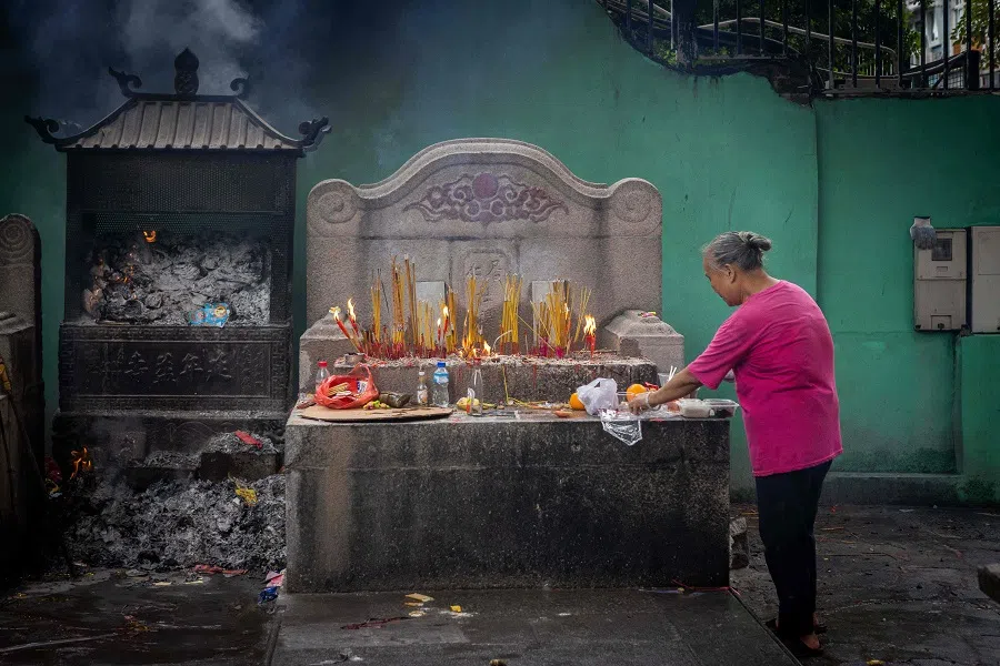 A caretaker arranges offerings during the Hungry Ghost Festival at Zhulin Temple in Macau on 17 August 2024. (Eduardo Leal/AFP)