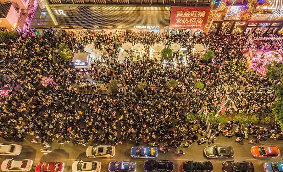 This aerial photo taken on 31 December 2022 shows pedestrians visiting a business area ahead of the new year in Nanning, Guangxi, China. (AFP)