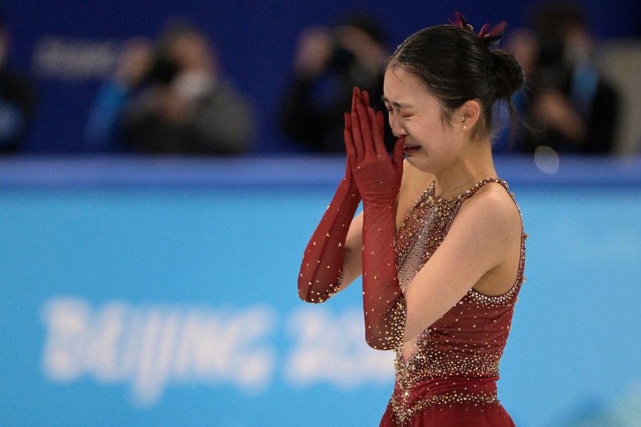 China's Zhu Yi reacts crying after competing in the women's single skating free skating of the figure skating team event during the Beijing 2022 Winter Olympic Games at the Capital Indoor Stadium in Beijing on 7 February 2022. (Sebastien Bozon/AFP)
