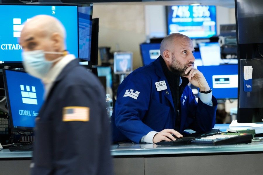 Traders work on the floor of the New York Stock Exchange (NYSE) on 15 November 2021 in New York City. (Spencer Platt/AFP)
