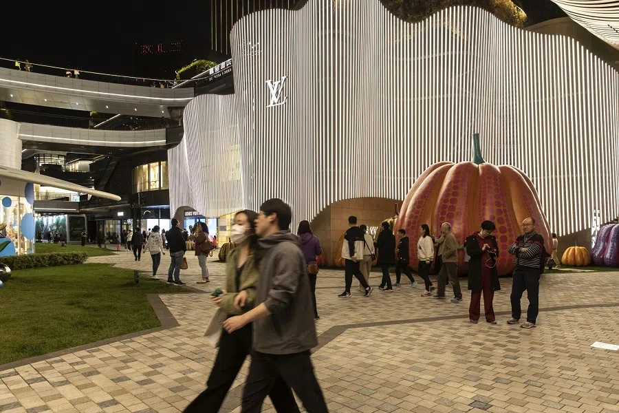 Visitors walk past a luxury store in Shanghai, China, on 29 April 2023. (Qilai Shen/Bloomberg)