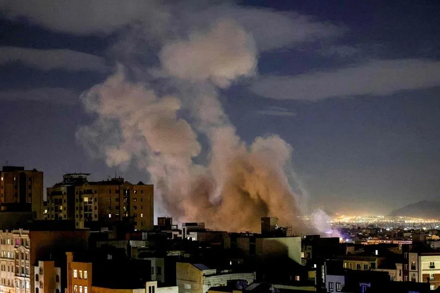 A smoke plume rises following a missile strike on a building in Tehran on 1 March 2026. (Atta Kenare/AFP)