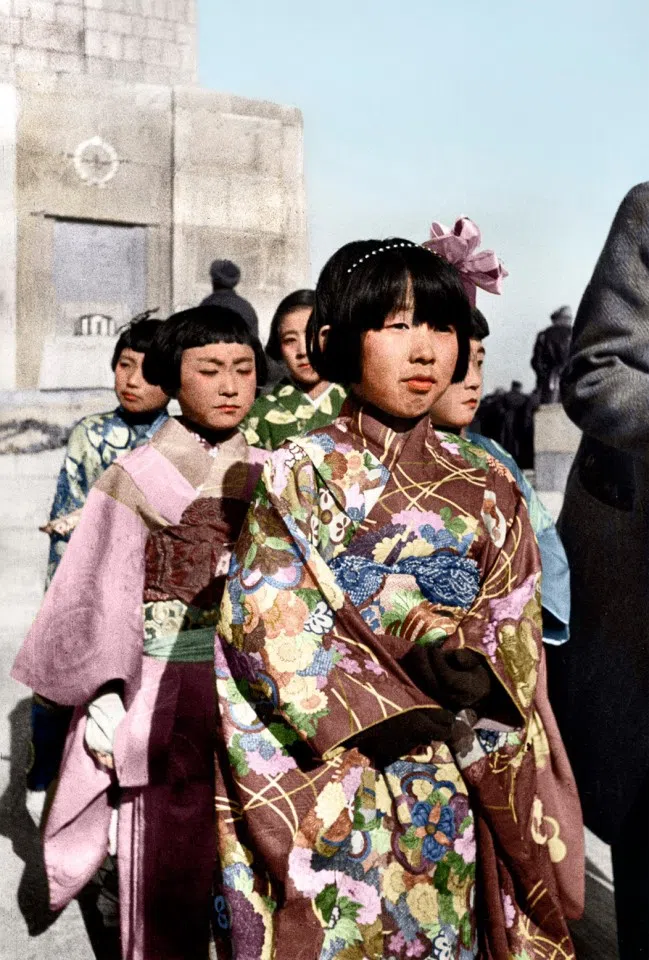 Some Japanese girls are appointed to offer flowers at a memorial to fallen Red Army soldiers in Changchun, November 1945.