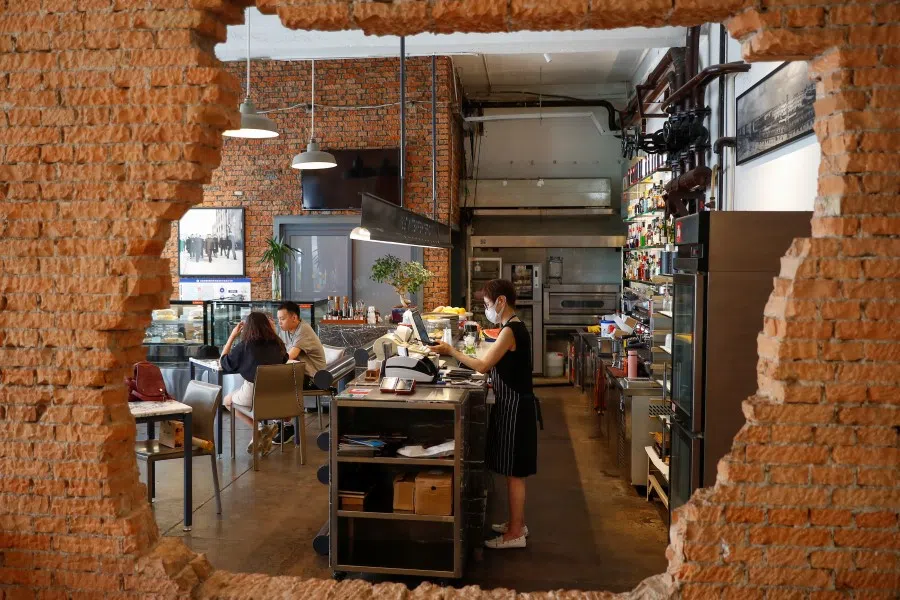 Customers sit in the local At Cafe at the 798 art district in Beijing, 6 July 2020. (Thomas Peter/REUTERS)
