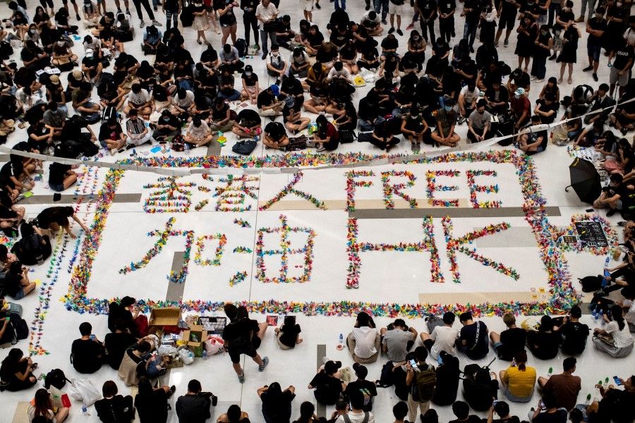 Anti-government protesters gather inside a mall in Sha Tin district in solidarity with the student protester who got shot by police with live ammunition in Hong Kong. (REUTERS)