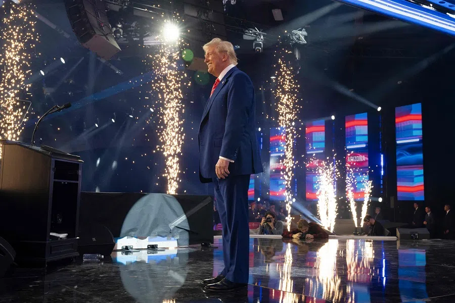 US President-elect Donald Trump exists the stage during Turning Point USA’s AmericaFest at the Phoenix Convention Center on 22 December 2024 in Phoenix, Arizona. (Rebecca Noble/Getty Images via AFP)