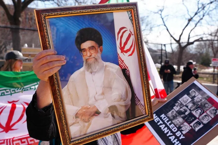 A protestor holds a portrait of late Iranian Supreme Leader Ali Khamenei during the International Day of al-Quds (Jerusalem Day) in support of Palestine in front of the White House in Washington, DC, on 14 March 2026. (Aaron Schwartz/AFP)