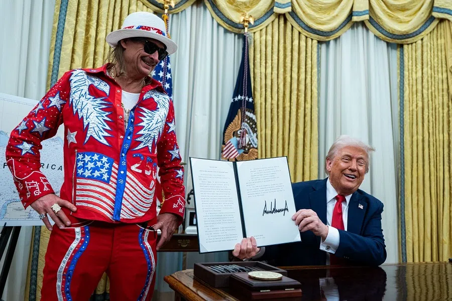 Singer Kid Rock (left), and US President Donald Trump during an executive order signing in the Oval Office of the White House in Washington, DC, US, on 31 March 2025. The order directs the Federal Trade Commission to work with the Department of Justice to ensure that competition laws are enforced in the concert and entertainment industry, and pushes state consumer protection authorities on enforcement. (Al Drago/Bloomberg)