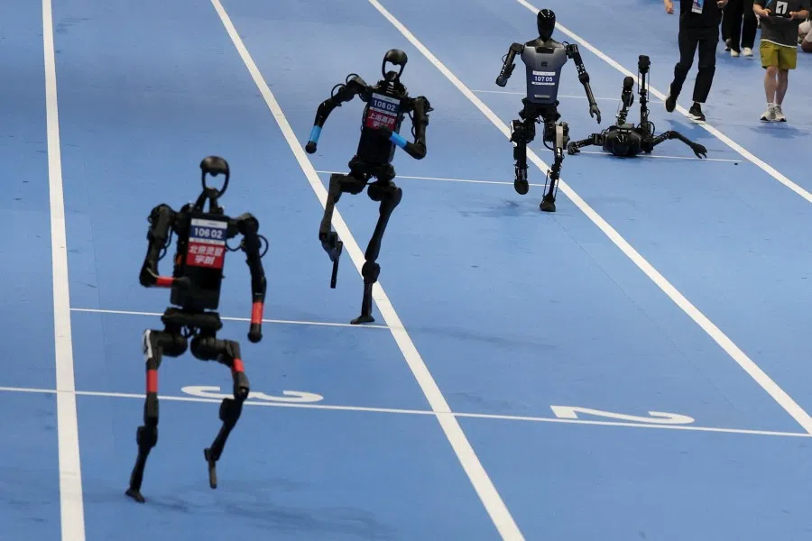 Unitree Robotics and Tiangong humanoid robots compete in the 100m final at the inaugural World Humanoid Robot Games, at the National Speed Skating Oval in Beijing, China, 17 August 2025. (Florence Lo/Reuters)