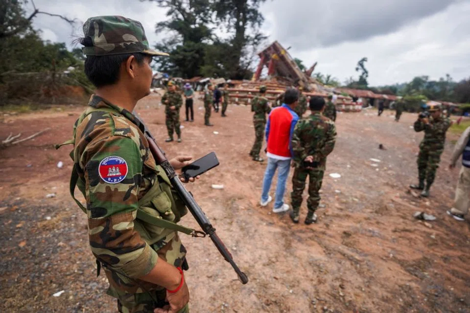 A military personnel takes position at the closed An Ses border checkpoint, also known as Chong Arn Ma in Thai, during an inspection by foreign military attaches from major powers and ASEAN member countries, along with diplomats from 13 countries, after the leaders of Cambodia and Thailand agreed to a ceasefire on 28 July effective midnight, Cambodia, 30 July 2025. (Soveit Yarn/Reuters)
