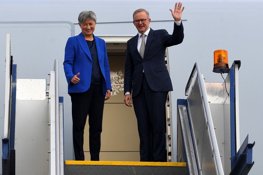 Australian Prime Minister Anthony Albanese, alongside Australian Foreign Minister Penny Wong, waves as the two board the plane to Japan to attend the Quad leaders meeting in Tokyo, in Canberra, Australia, 23 May 2022. (AAP Image/Lukas Coch via Reuters)