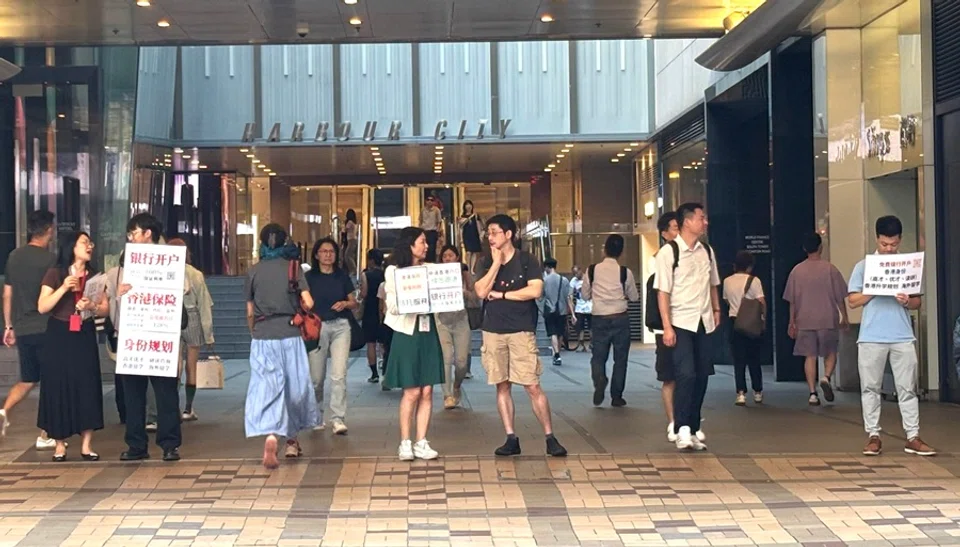 The photo shows several insurance brokers and agents holding advertisement boards on the streets of Tsim Sha Tsui, Hong Kong, on 6 June 2025. Many of these individuals are xin gang piao from the mainland settling in Hong Kong. (Lim Zhan Ting/SPH Media)