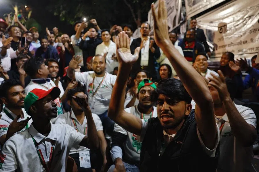 Supporters of the Bangladesh Nationalist Party (BNP) chant slogans as they celebrate unofficial news of Tarique Rahman's win in his constituency in the 13th general election near the party's Gulshan office in Dhaka, Bangladesh, on 12 February 2026. (Mohammad Ponir Hossain/Reuters)