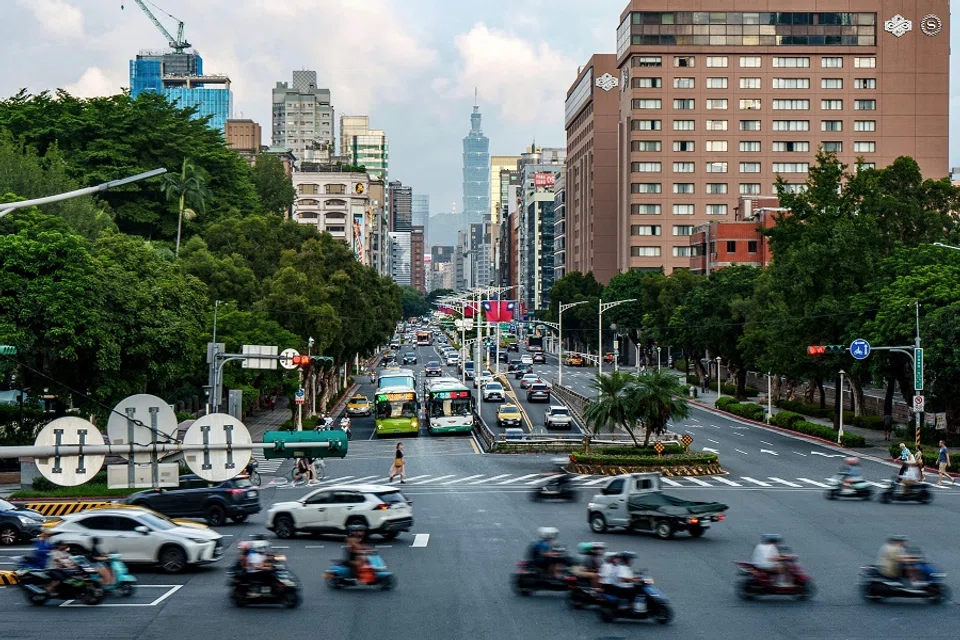 Commuters ride along a street with the skyscraper Taipei 101 in the background in Taipei, Taiwan, on 28 September 2024. (Yan Zhao/AFP)