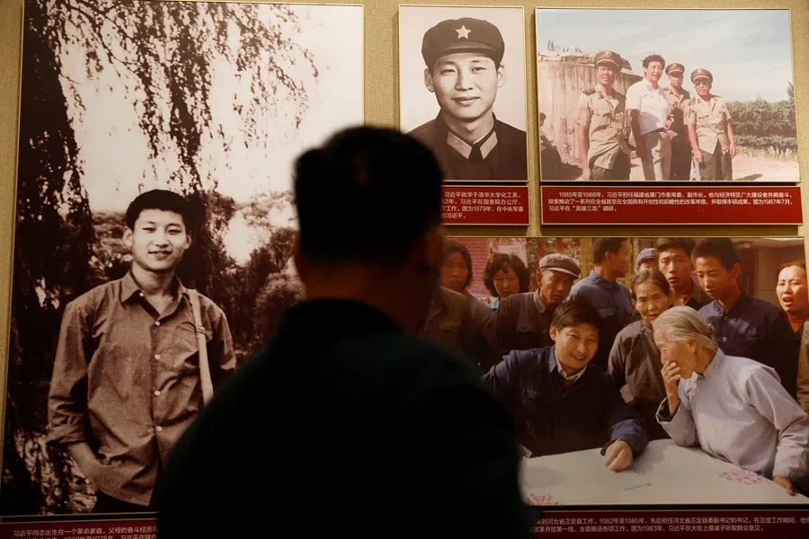 A man stands in front of images of Chinese President Xi Jinping displayed at the Museum of the Communist Party of China in Beijing, China, on 11 November 2021.