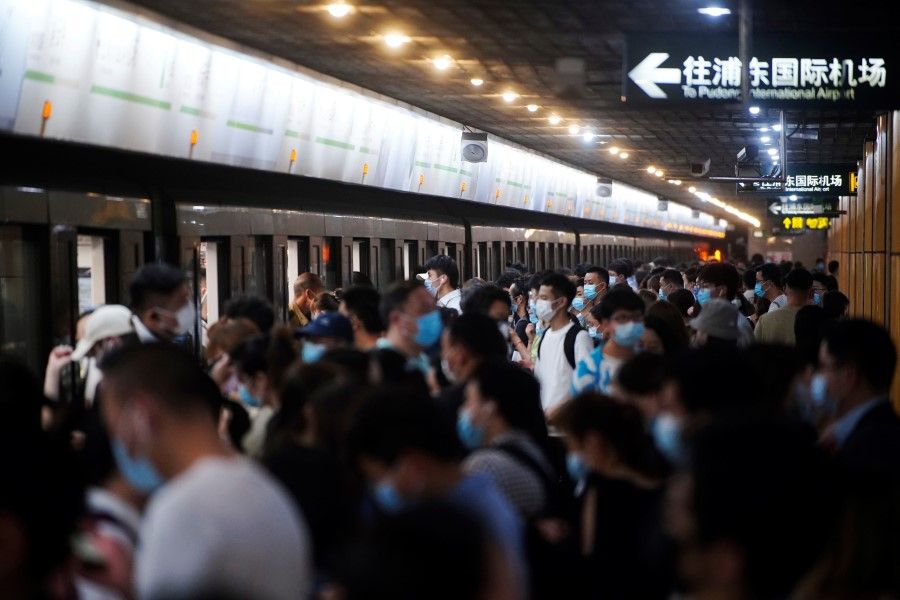 People at a subway station in Shanghai, China, 11 May 2021. (Aly Song/Reuters)