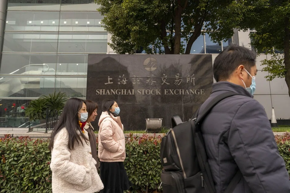 People walking past the signage for the Shanghai Stock Exchange in Pudong’s Lujiazui Financial District in Shanghai, China, on 29 January 2024. (Raul Ariano/Bloomberg)