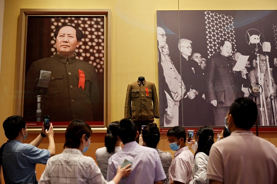 People view images of the late Chairman Mao Zedong of the Chinese Communist Party at the Museum of the Communist Party of China that was opened ahead of the 100th anniversary of the party in Beijing, China, 25 June 2021. (Thomas Peter/Reuters)
