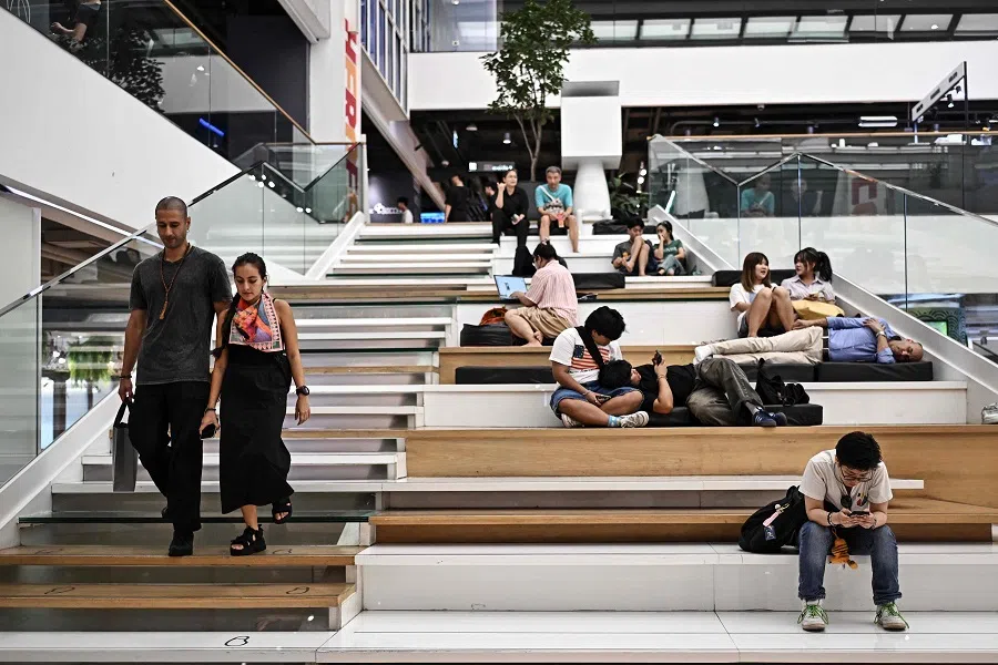 People rest inside a shopping mall in Bangkok, Thailand, on 25 April 2025. (Lillian Suwanrumpha/AFP)