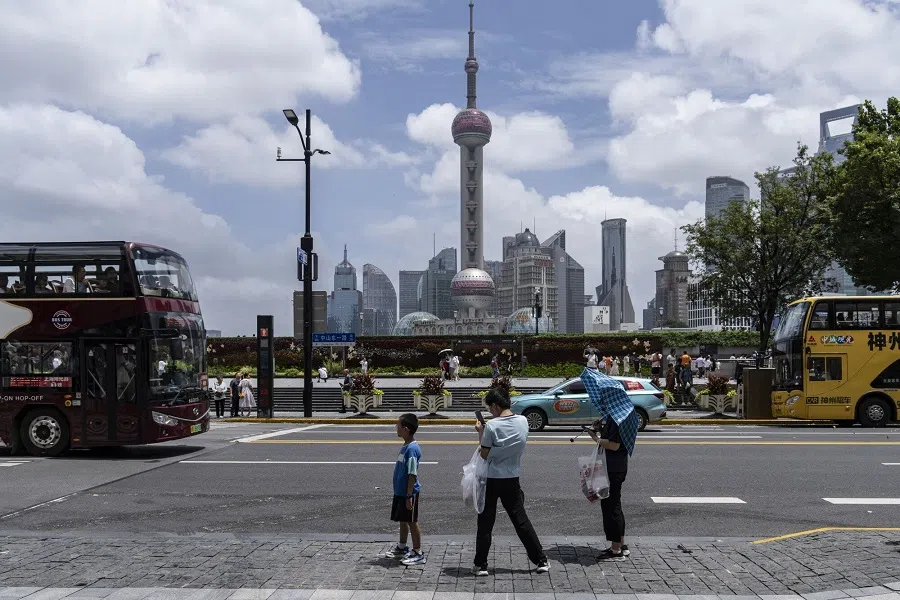 Pedestrians walk on the Bund in Shanghai, China, on 27 July 2024.