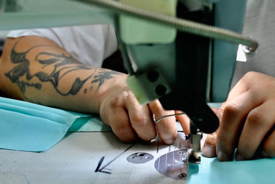An inmate operates a sewing machine as he and others make face masks at Taipei Prison. (Sam Yeh/AFP)