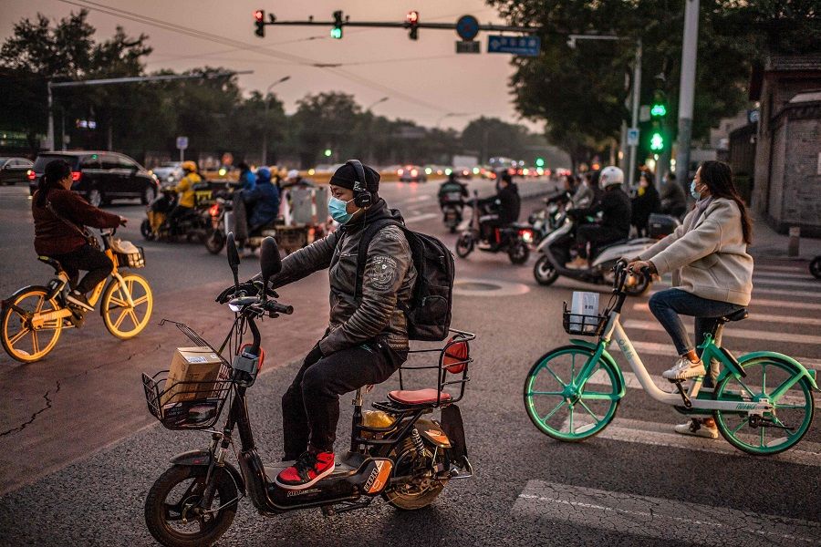 People wearing face masks commute during rush hour in Beijing on 15 October 2020. (Nicolas Asfouri/AFP)