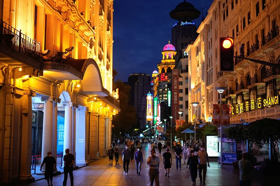 People walk in a main shopping area in Shanghai, China, 31 May 2022. (Aly Song/Reuters)