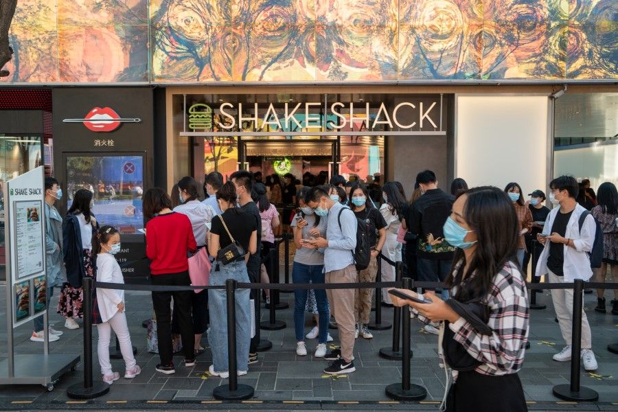 Customers wait in line outside a Shake Shack Inc. restaurant in Beijing, China on 20 September 2020. (Yan Cong/Bloomberg)