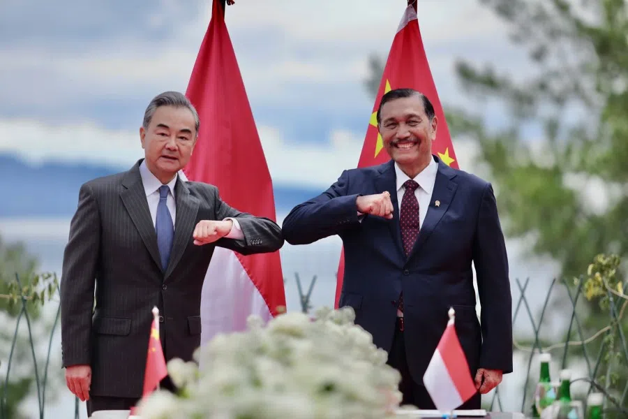 This handout photo taken on 13 January 2021 by Indonesia's Ministry of Maritime and Investment Affairs shows Chinese Foreign Minister Wang Yi (left) meeting with Indonesian Coordinating Maritime Affairs and Investments Minister Luhut Pandjaitan in Parapat, on the edge of Lake Toba in North Sumatra, to discuss cooperation on investments. (Handout/Ministry of Maritime and Investment Affairs/AFP)