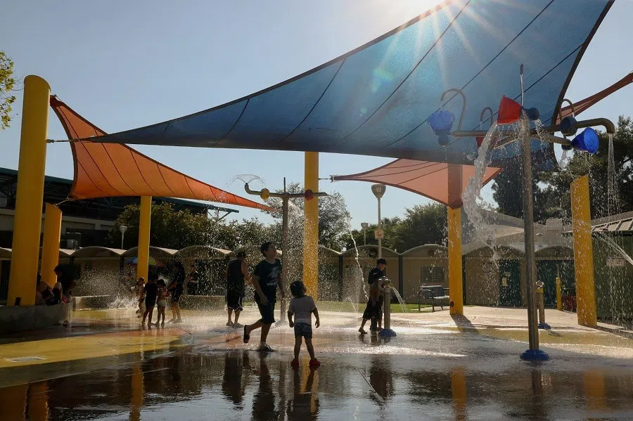 People and children cool down and play near a cooling centre located in a park in Los Angeles, California, US, on 5 September 2024. (Etienne Laurent/Reuters)