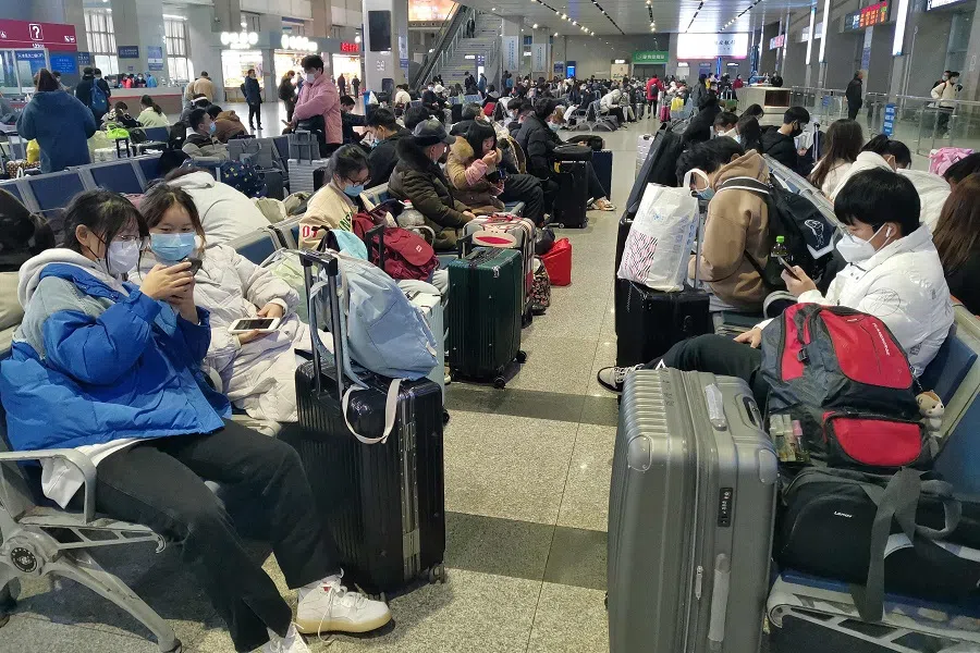 Passengers wait for their trains at Yichang East Railway Station in Hubei province, China, on 8 December 2022, following the easing of Covid-19 restrictions in the city. (AFP)