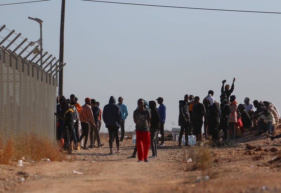 Migrants gather outside the Kokkinotrimithia refugee camp, on the outskirts of Nicosia, Cyprus, 9 November 2021. (Yiannis Kourtoglou/Reuters)