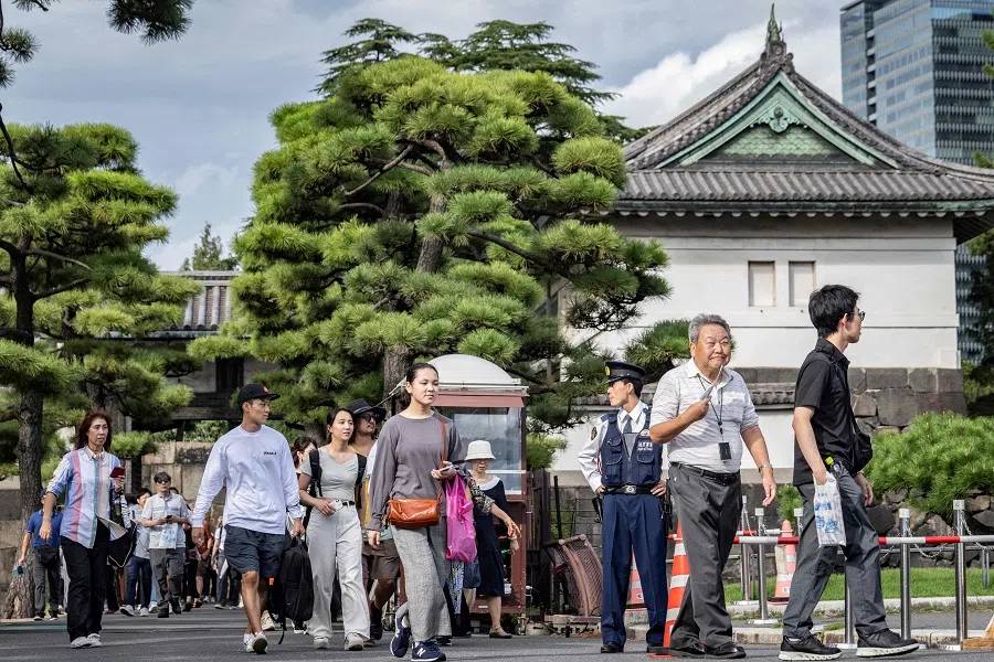 People visit the Imperial Palace in Tokyo on 4 October 2024. (Yuichi Yamazaki/AFP)