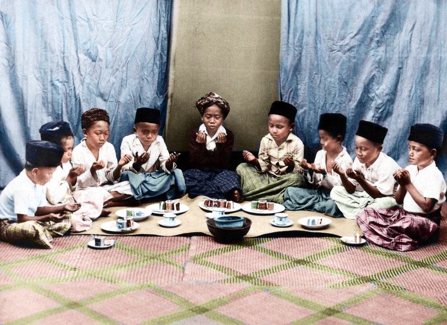 Muslim students in Indonesia take part in a ceremony, 1920s. From a young age, children are familiar with religious practices and pray devoutly.