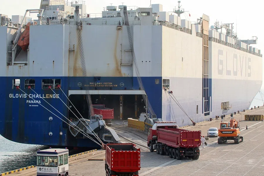 Construction vehicles that will be exported to East Africa are loaded on a cargo ship at a port in Yantai in China's Shandong province on 28 April 2020. (STR/AFP)