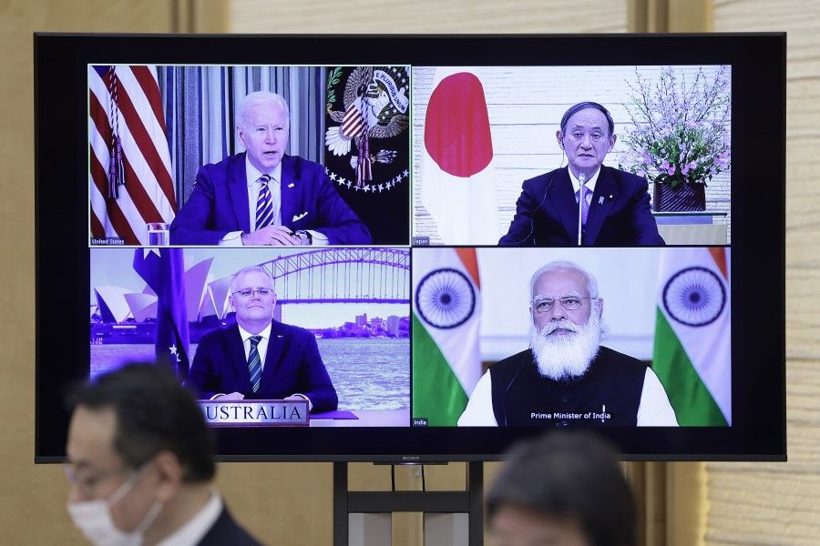 U.S. President Joe Biden (top left), Yoshihide Suga, Japan's prime minister (top right), Scott Morrison, Australia's prime minister (bottom left), and Narendra Modi, India's prime minister, on a monitor during the virtual Quadrilateral Security Dialogue (Quad) meeting at Suga's official residence in Tokyo, Japan, on 12 March 2021. (Kiyoshi Ota/Bloomberg)