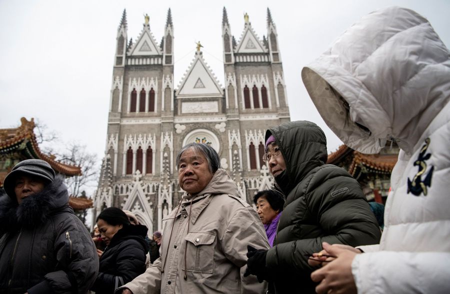 Worshippers attend a Christmas eve mass at the Xishiku Cathedral in Beijing on 24 December 2019. (Noel Celis/AFP)