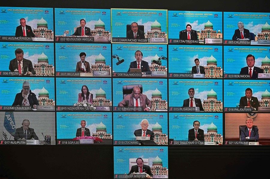 A screen shows the virtual meeting between world leaders, including US President Donald Trump (bottom R), Russian President Vladimir Putin (bottom L) and Chinese President Xi Jinping (L, second row from top), during the online Asia-Pacific Economic Cooperation (APEC) leaders' summit in Kuala Lumpur on 20 November 2020. (Mohd Rasfan/AFP)