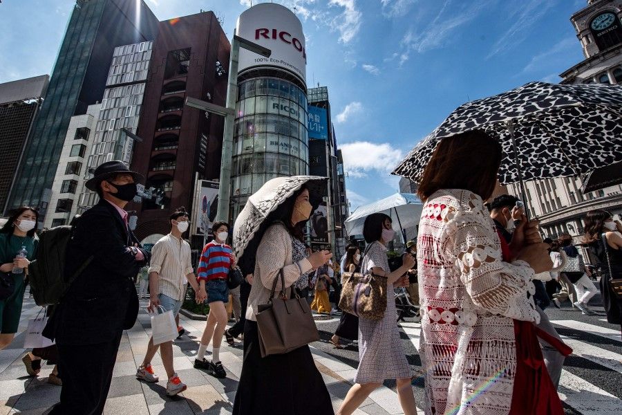 Pedestrians cross a street in Tokyo's Ginza district on 17 July 2022. (Philip Fong/AFP)