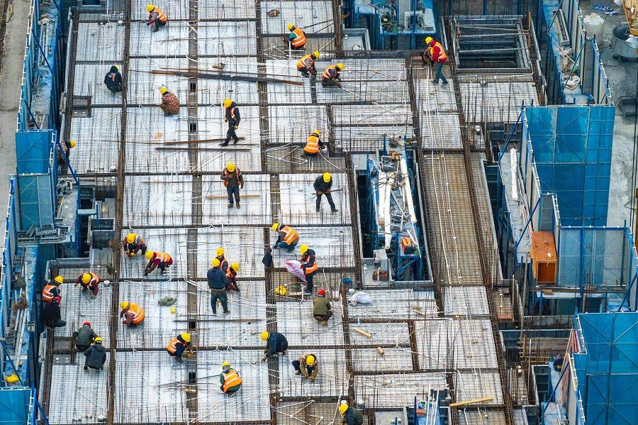 This aerial photo taken on 21 January 2024 shows workers at a construction site of residential buildings in Huaian, in China's eastern Jiangsu province. (AFP)