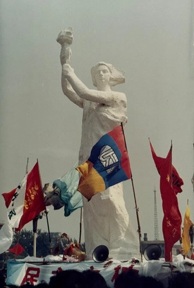 The Goddess of Democracy statue being raised.