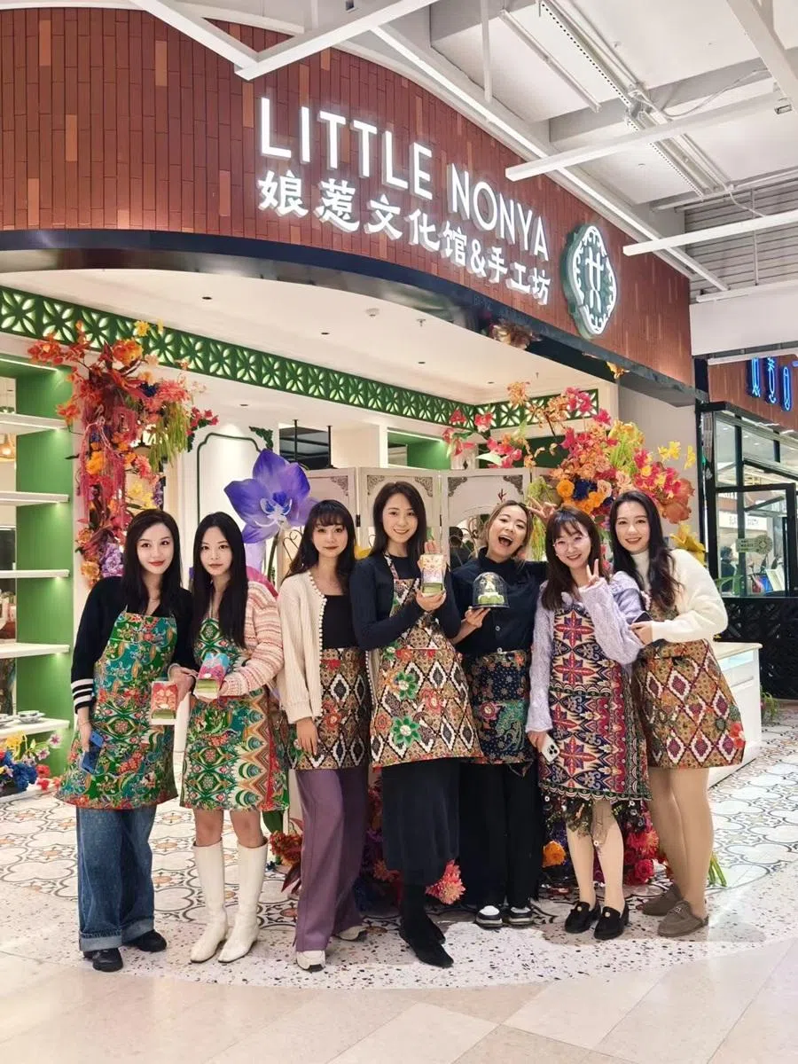 Little Nonya founder Liao Xuemin (third from right) in a picture with customers at store in Shanghai taken on December 2024. (Photo provided by interviewee)